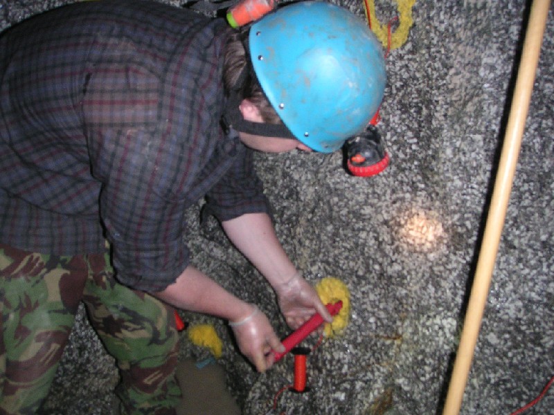 charles loading holr.JPG - Charlie, loading a stick of gelignite into a charge hole. Note the gloves for protection against a 'nytro head ache'.